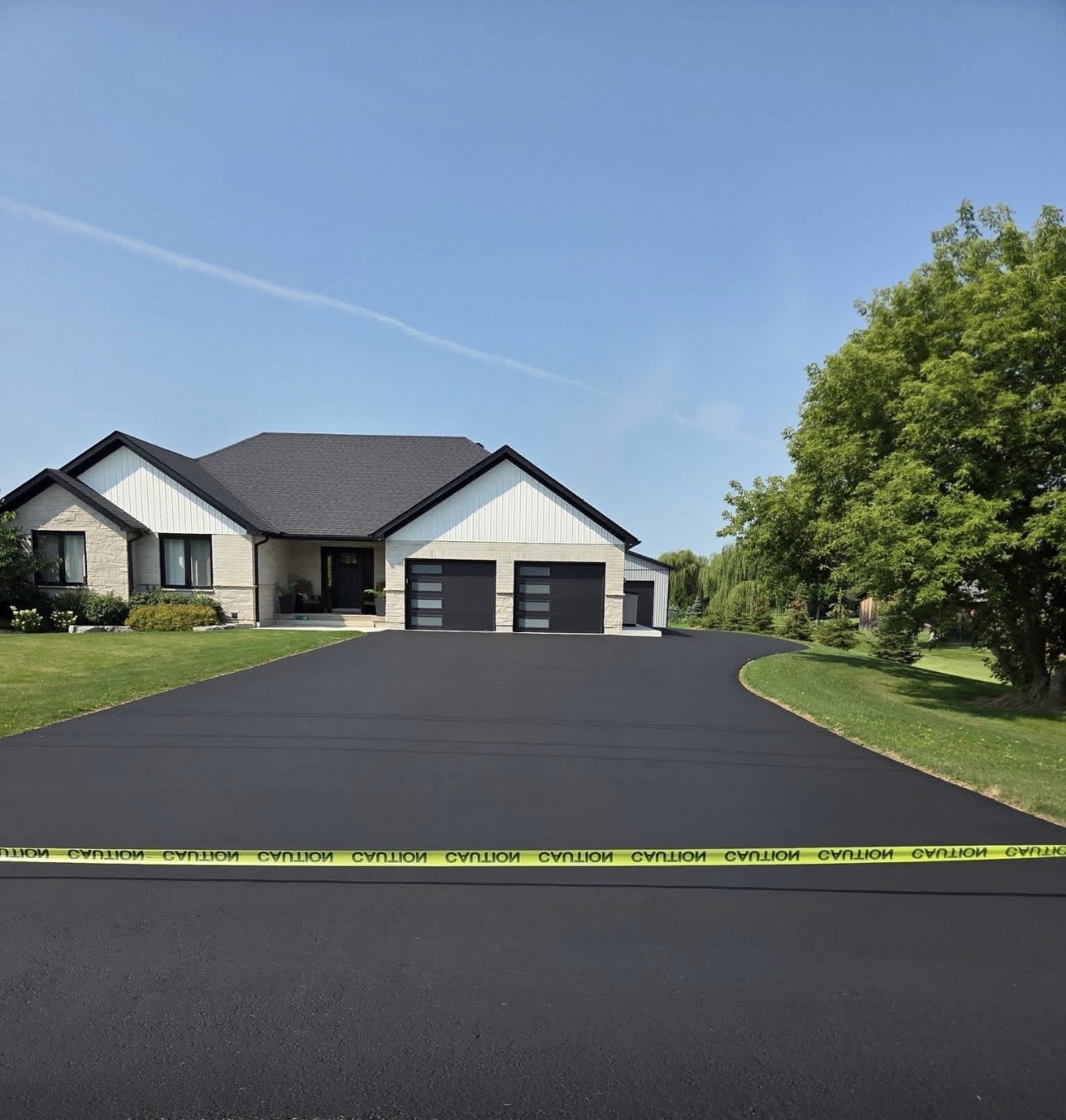 Same large residential driveway after sealing