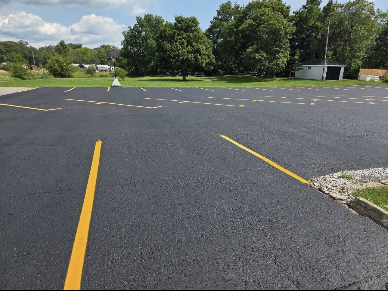 Sealed commercial parking lot with fresh yellow lines